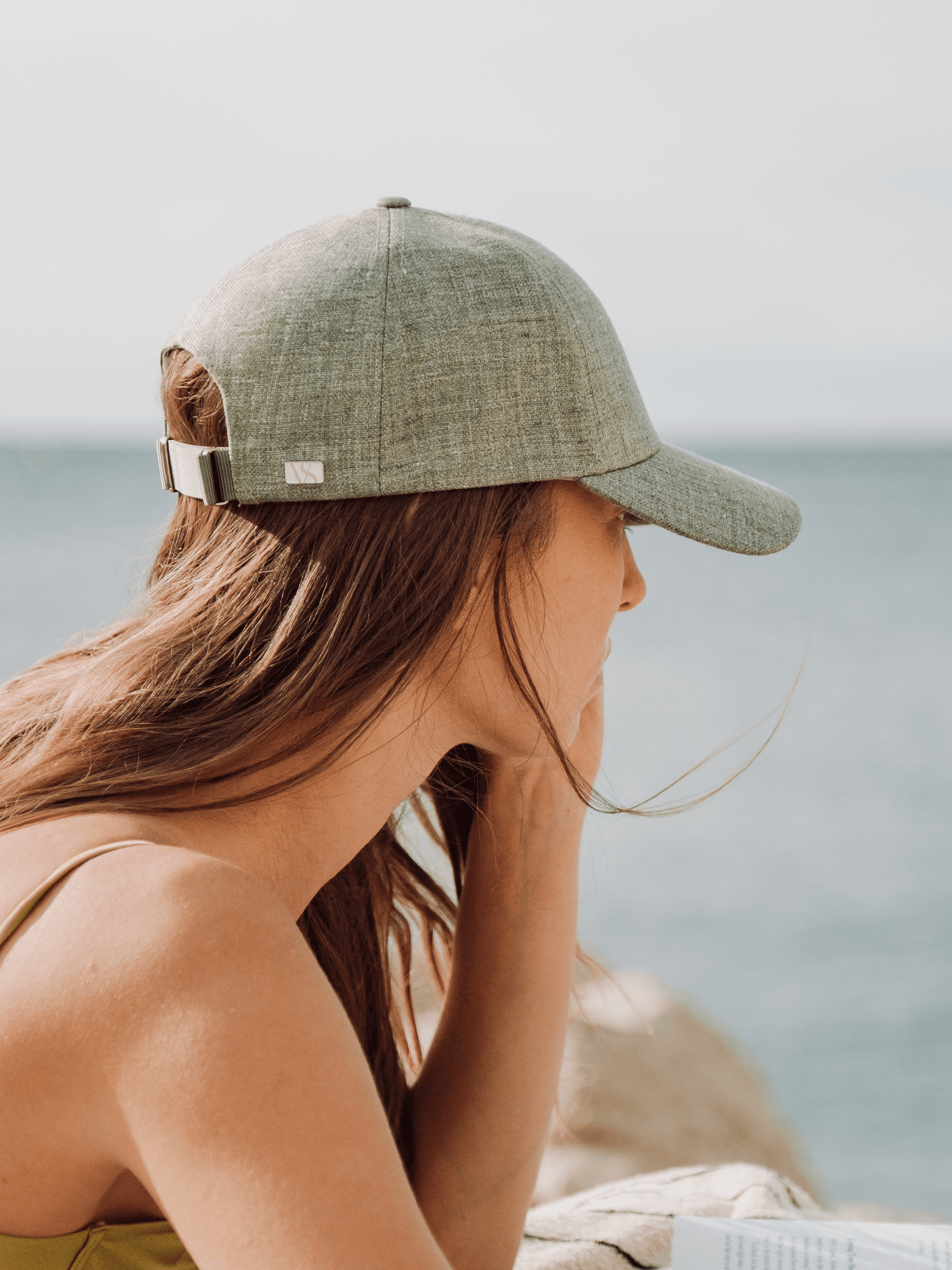 Side view of a green linen summer cap from varsity headwear
