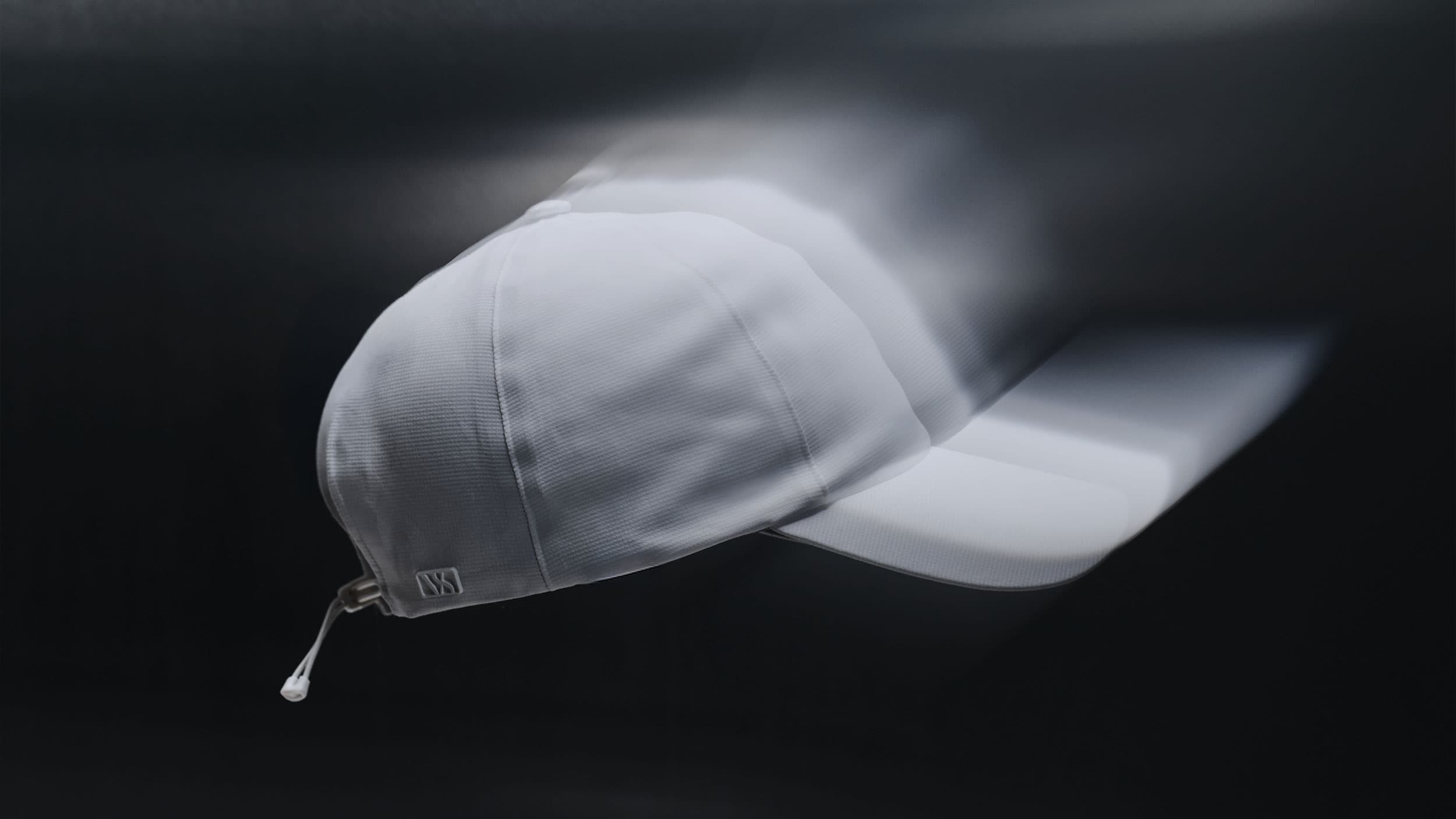 Side view of a white high intensity sport cap from varsity headwear in motion