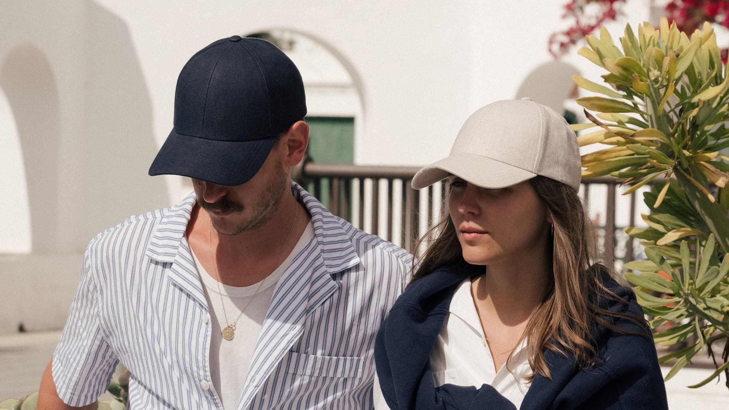 Male and female wearing blue and beige linen caps from varsity headwear