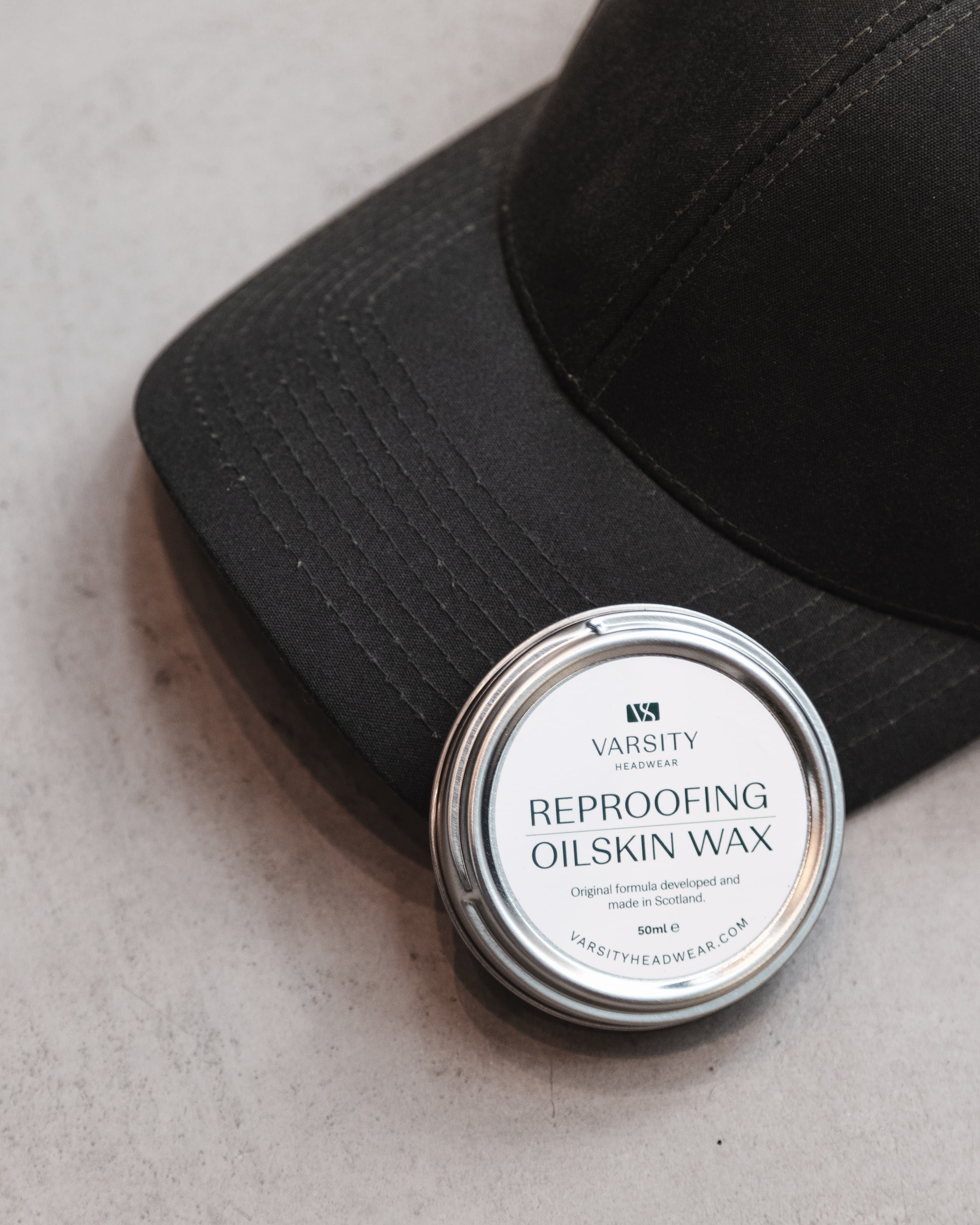 Black oilskin cap from varsity headwear with a reproofing oilskin wax