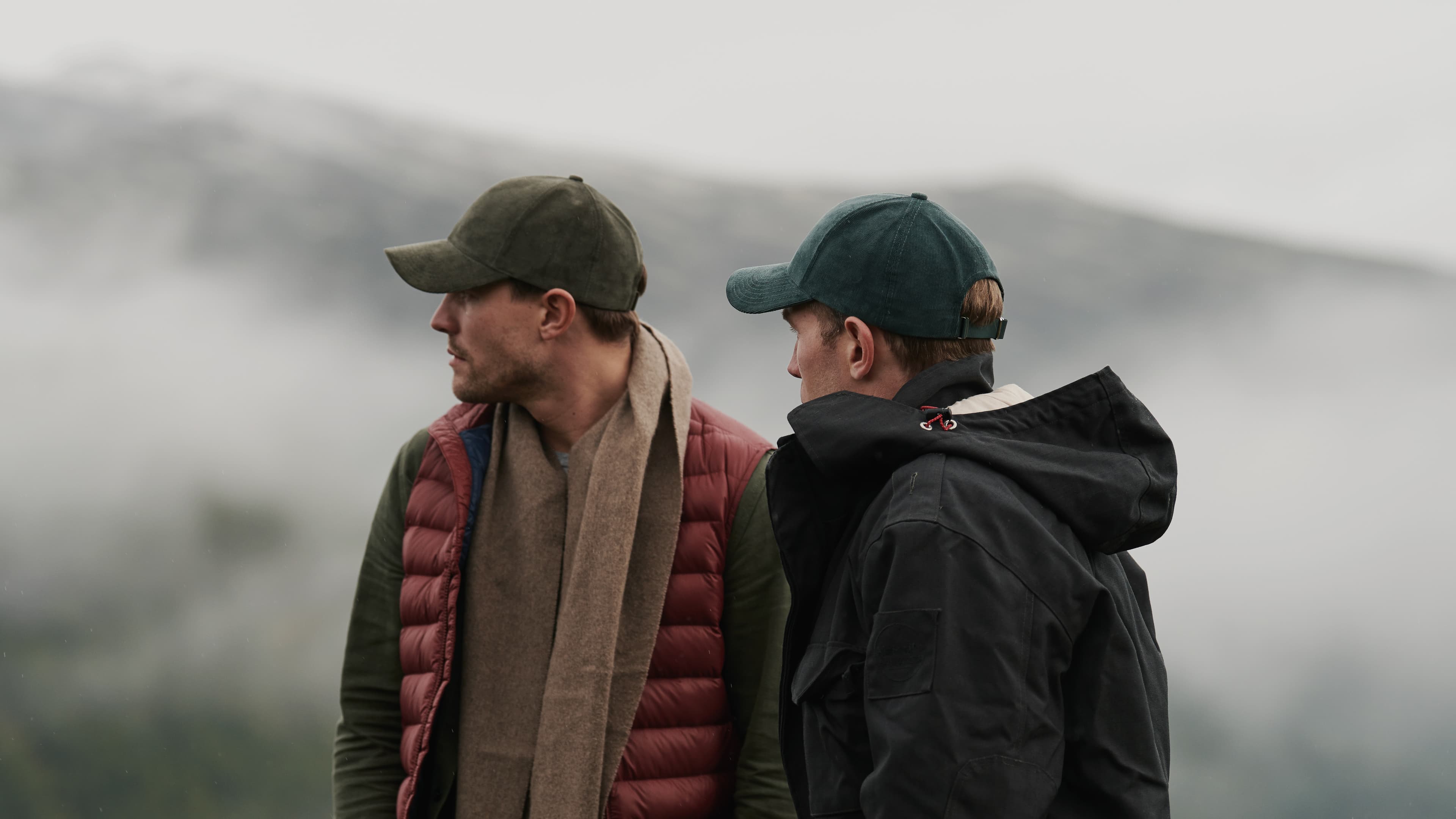 Side view of founders of Varsity Headwear Alex and Seb with caps on in Norwegian landscape