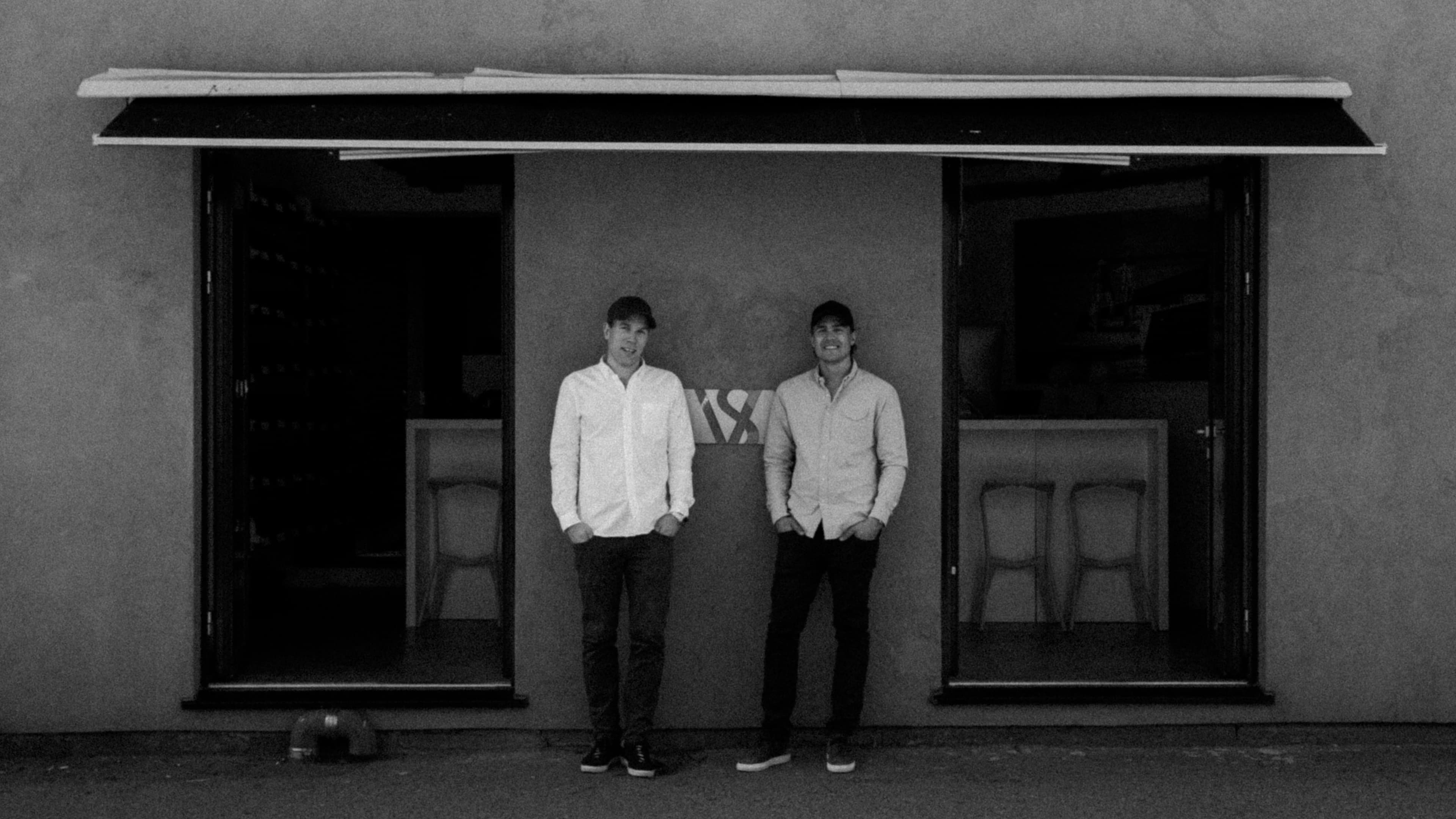 Founders of Varsity Headwear in front of their first Oslo store