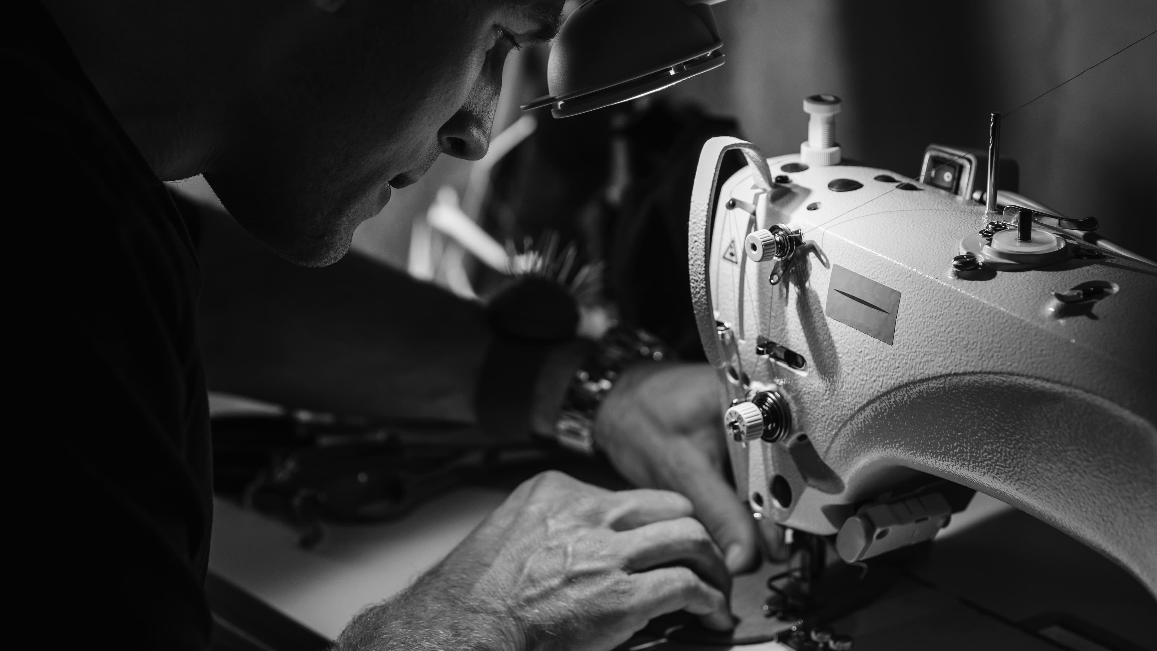 Designer working with materials on sewing machine